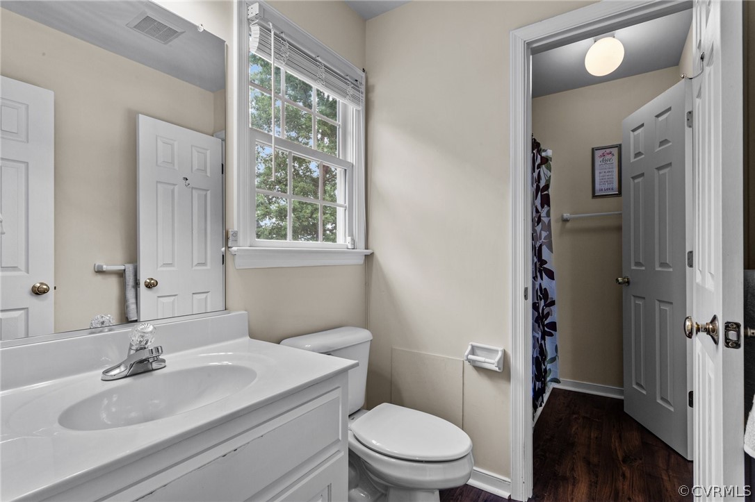 9437 Dunroming Road Chesterfield, VA 23832 - Photo 36 of 40 a bathroom with a granite countertop sink toilet a mirror and shower