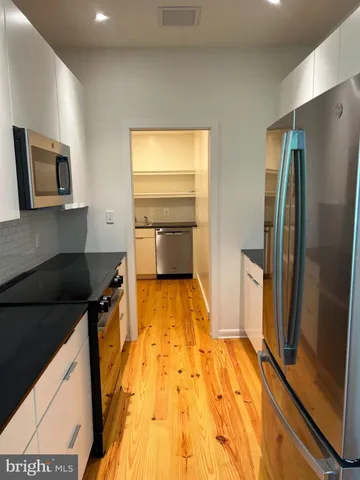 a kitchen with stainless steel appliances a refrigerator and a stove