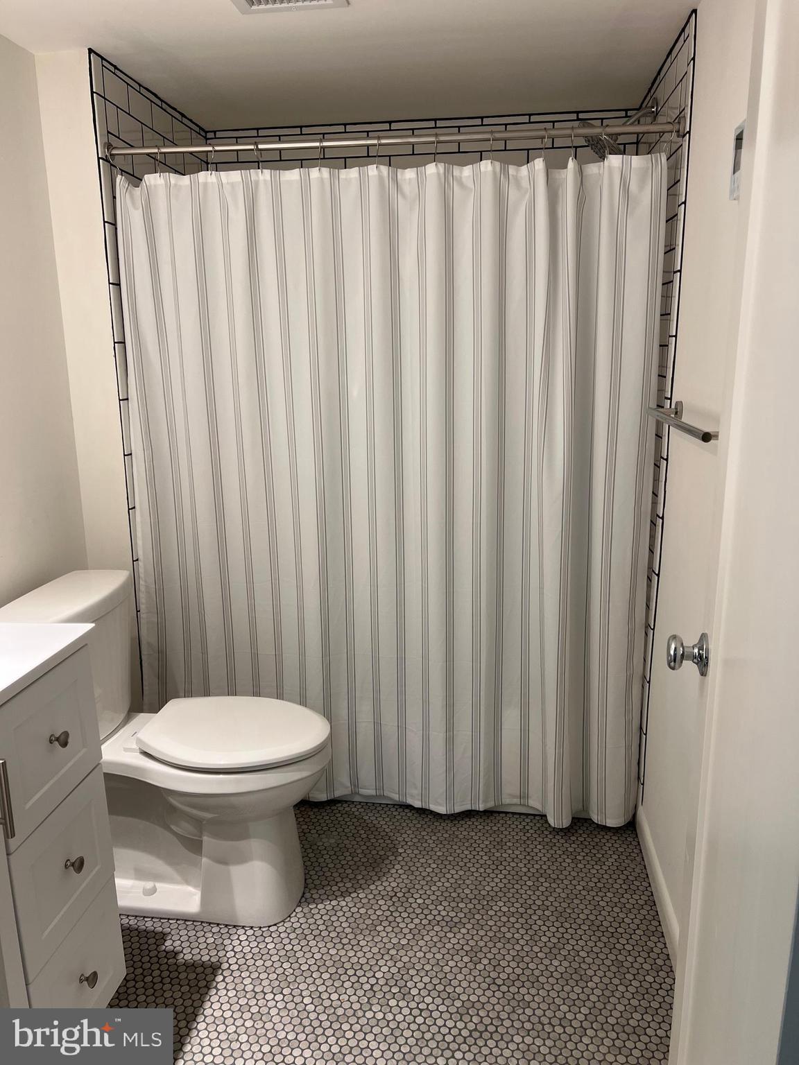 48 Waller Point Drive Stafford, VA 22554 - Photo 27 of 43 a bathroom with a toilet and a shower curtain