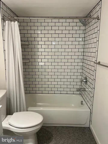 a bathroom with a toilet and a bathtub