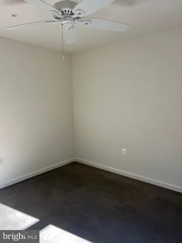 a view of a room with an empty space and a ceiling fan