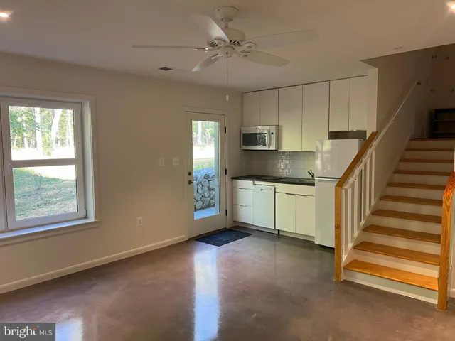 a open kitchen with cabinets a sink and appliances