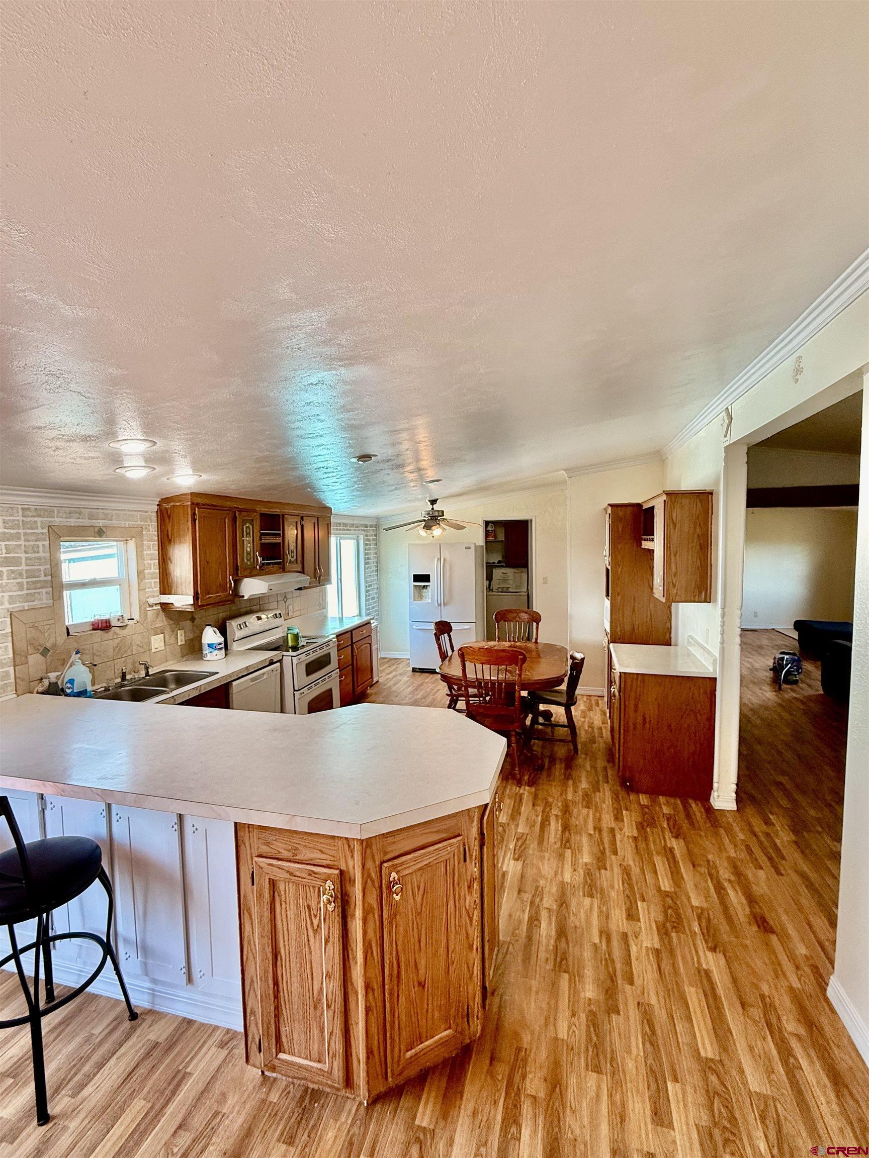 23825 Rd F.4 Cortez, CO 81321 - Photo 12 of 18 a large kitchen with stainless steel appliances a large counter top and couch