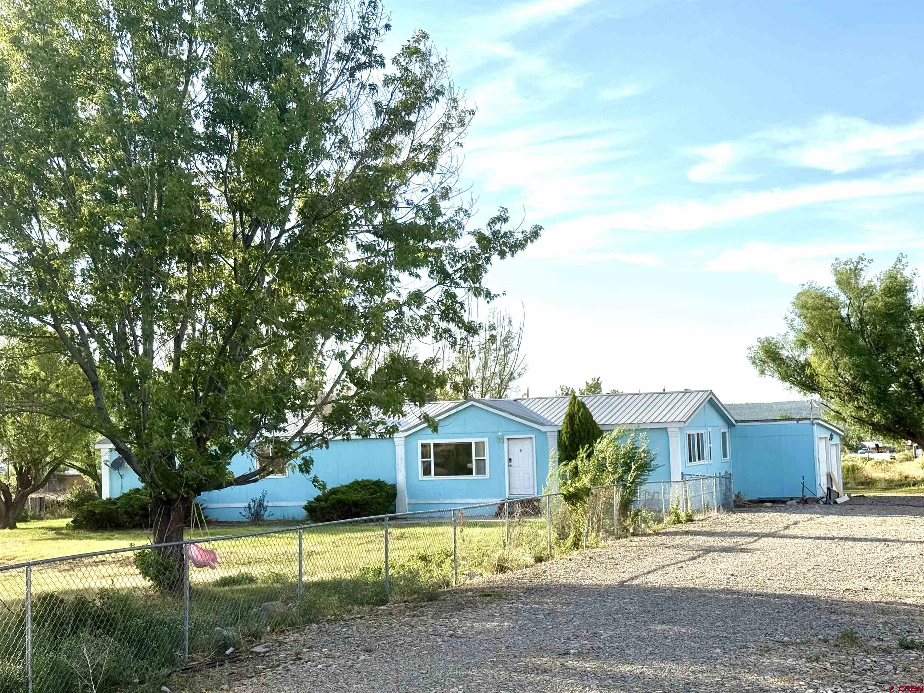 23825 Rd F.4 Cortez, CO 81321 - Photo 2 of 18 a view of a house with a tree in front of it