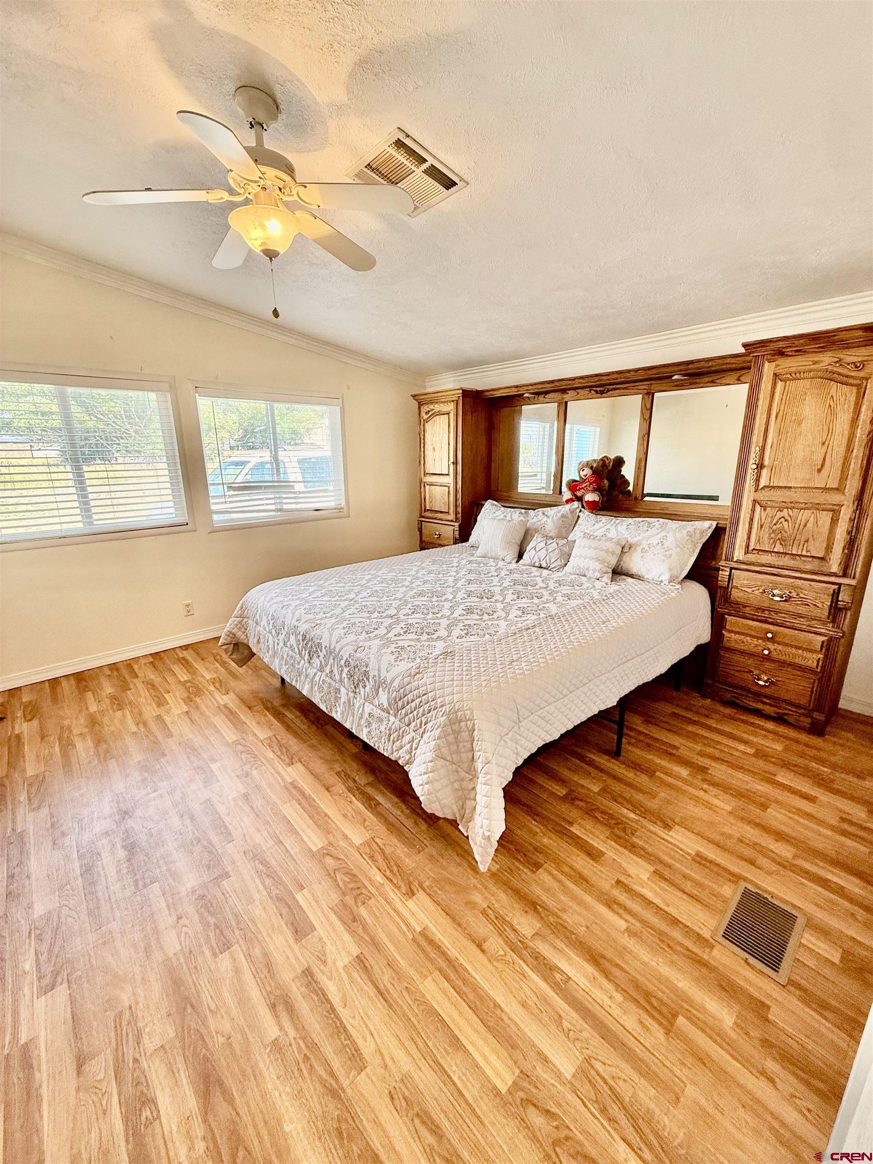 23825 Rd F.4 Cortez, CO 81321 - Photo 10 of 18 a spacious bedroom with a bed and wooden floor