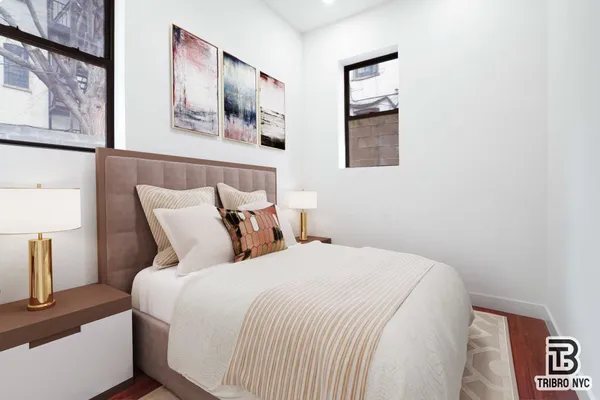 a bed room with a bed and painting on the wall