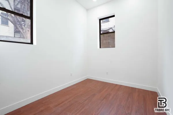 a room with a wooden floor and a window