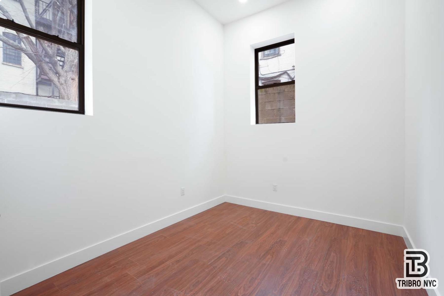 217 South 4th Street, Unit LOFT1 Brooklyn, NY 11211 - Photo 8 of 12 a room with a wooden floor and a window