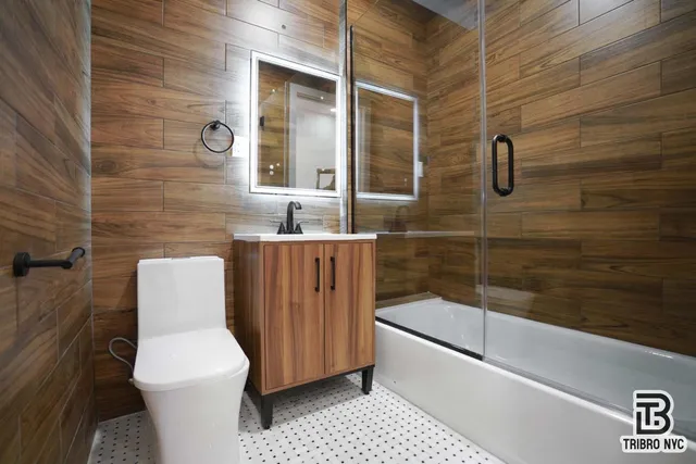 a bathroom with a toilet a sink and bathtub