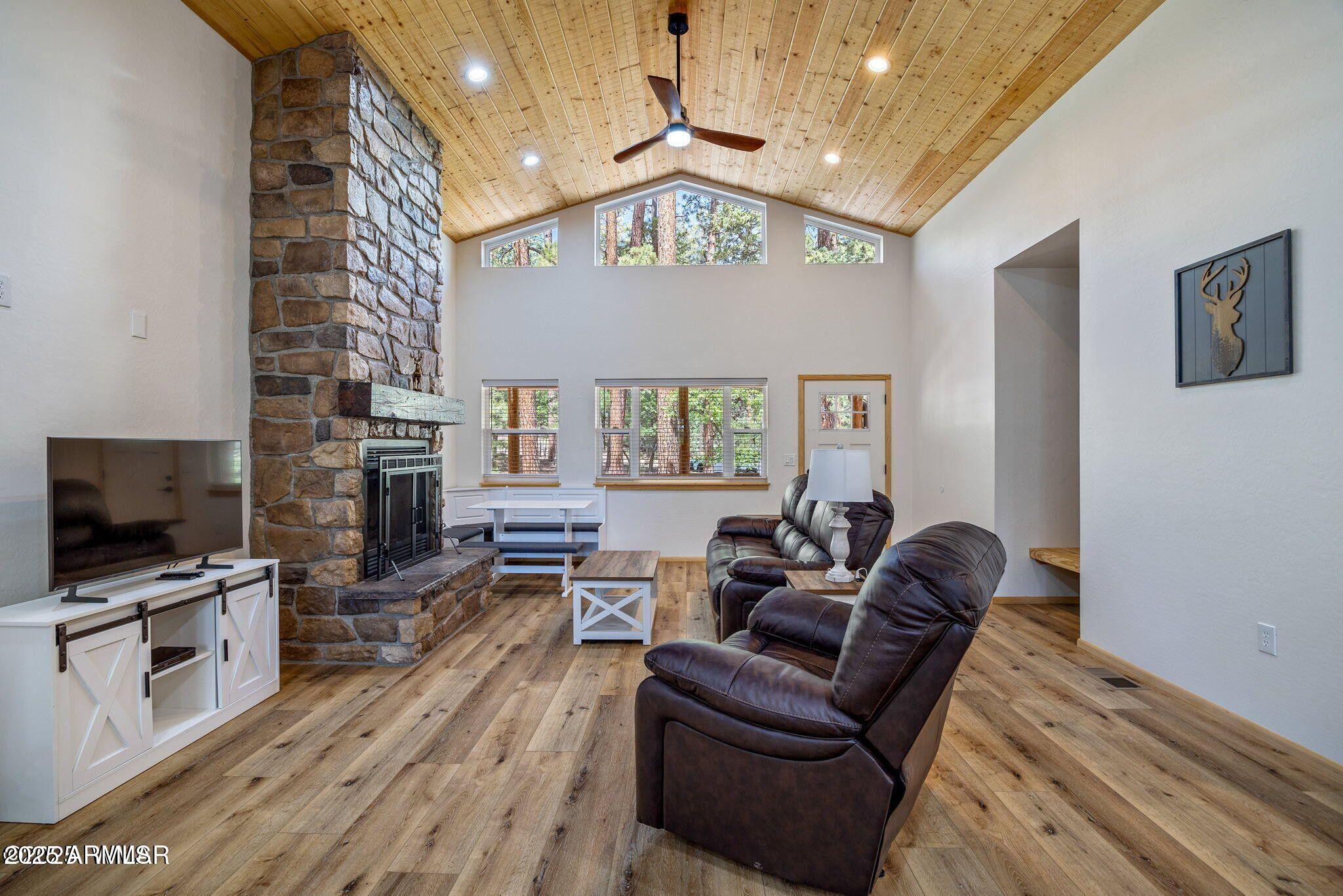 26 County Road 2067 Alpine, AZ 85920 - Photo 15 of 33 a living room with furniture a flat screen tv and a floor to ceiling window
