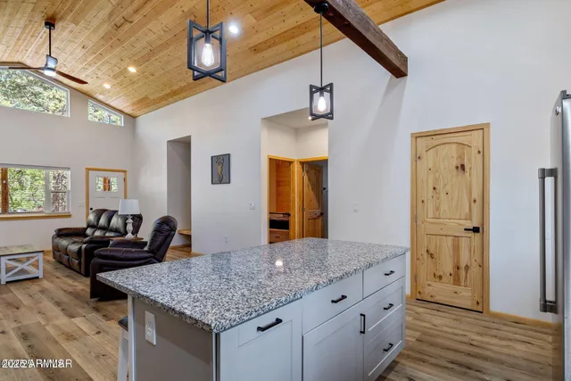 a kitchen with stainless steel appliances granite countertop a stove cabinets and wooden floor