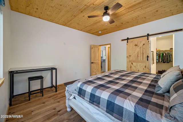 a bedroom with a bed and a chandelier