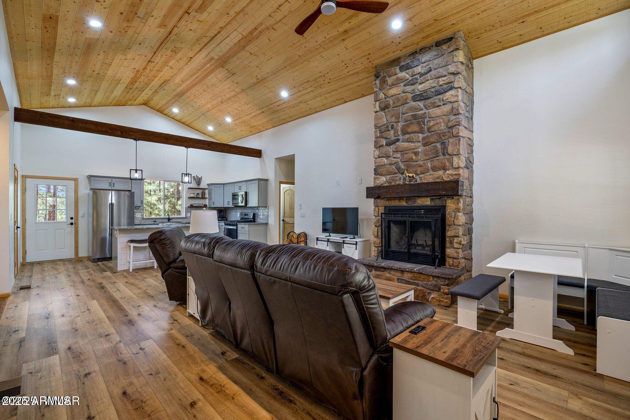 26 County Road 2067 Alpine, AZ 85920 - Photo 2 of 33 a living room with furniture and a fireplace