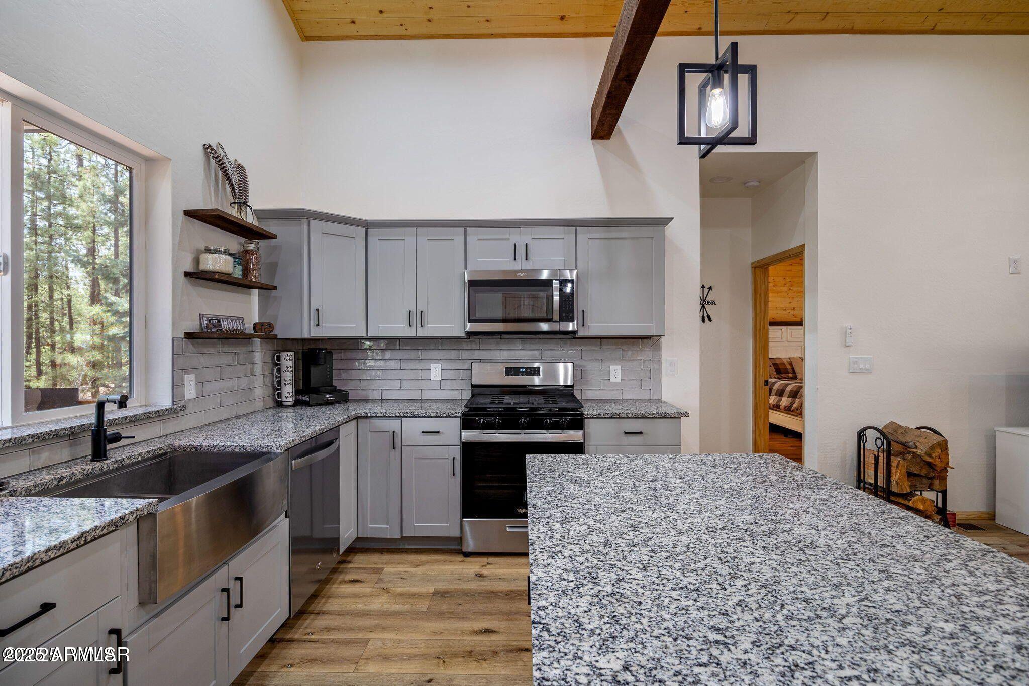 26 County Road 2067 Alpine, AZ 85920 - Photo 6 of 33 a kitchen with a stove and a sink