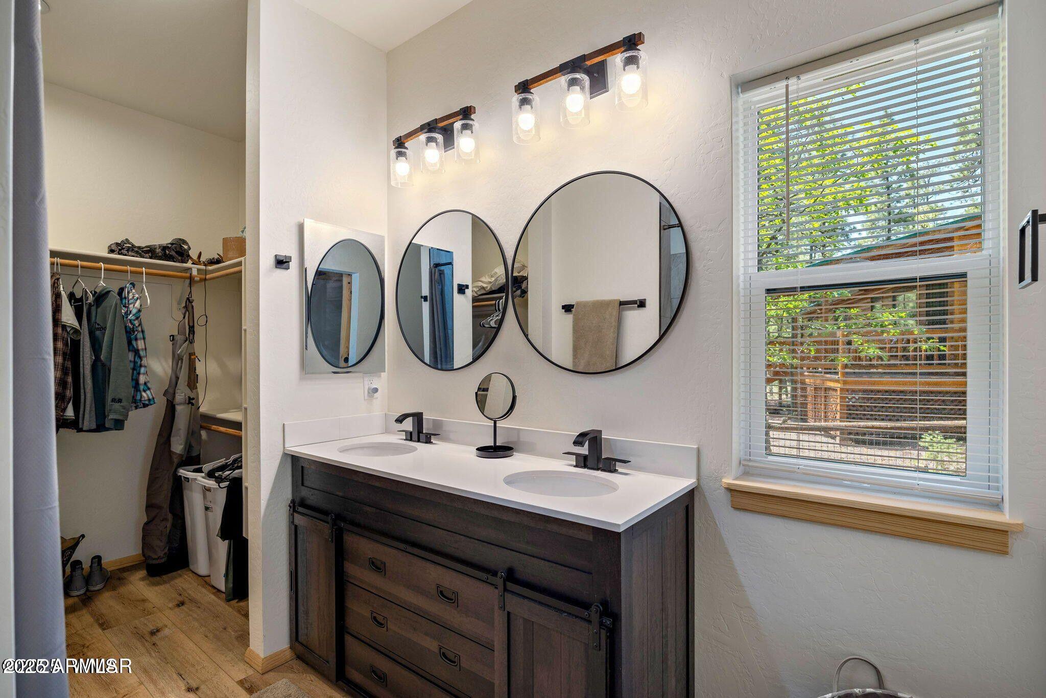 26 County Road 2067 Alpine, AZ 85920 - Photo 8 of 33 a bathroom with a sink a mirror a window and a shower