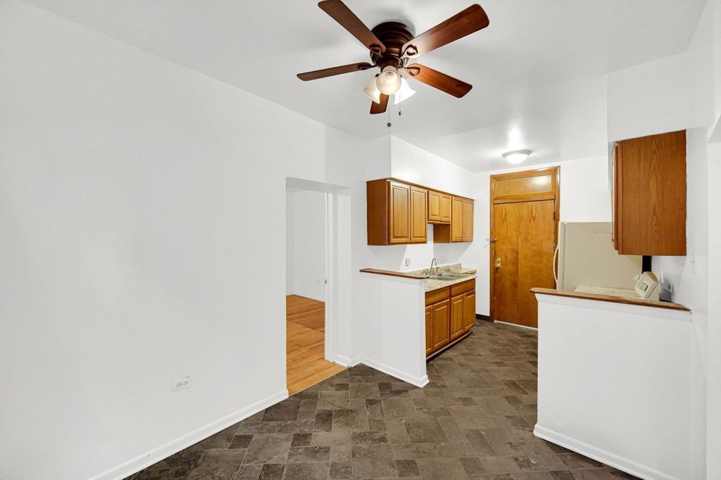 7017 South Merrill Avenue, Unit 305 Chicago, IL 60649 - Photo 13 of 20 a kitchen with a refrigerator a sink and dishwasher