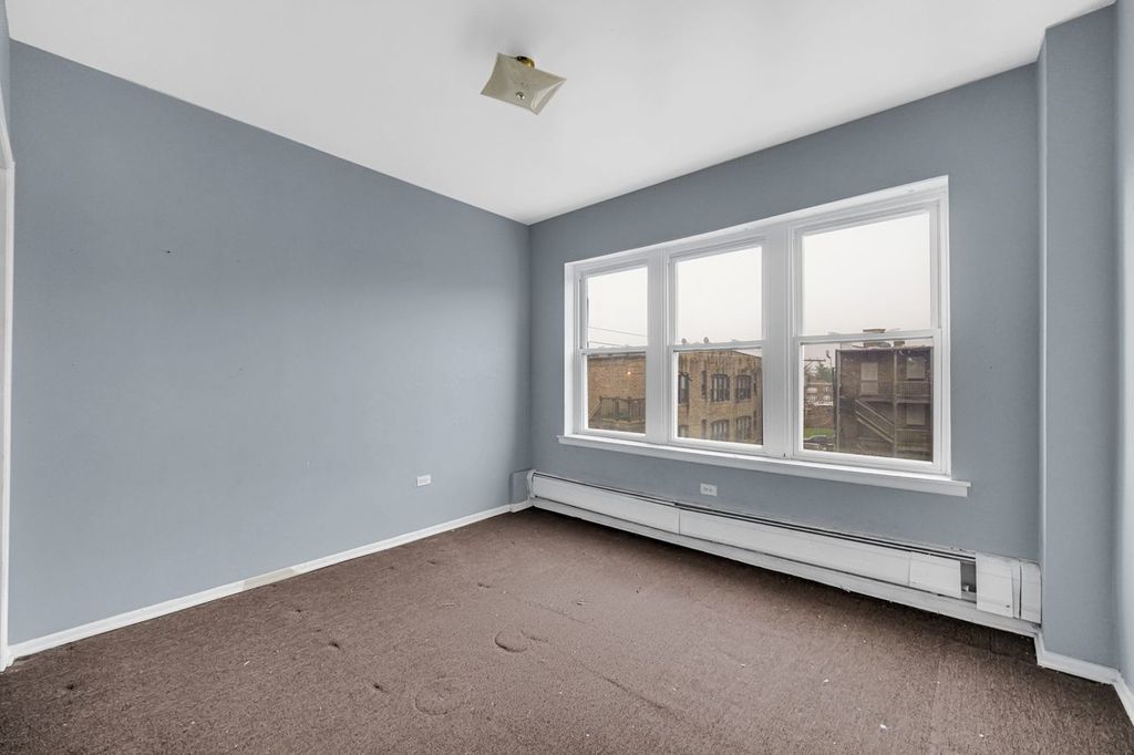 7017 South Merrill Avenue, Unit 305 Chicago, IL 60649 - Photo 17 of 20 a view of an empty room with a window