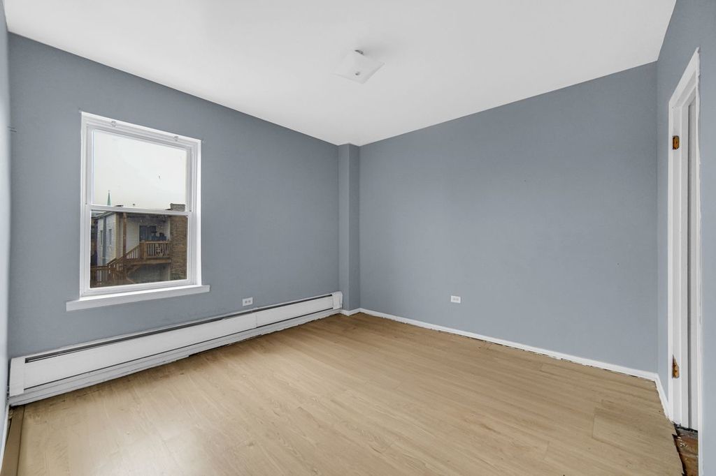 7017 South Merrill Avenue, Unit 305 Chicago, IL 60649 - Photo 18 of 20 an empty room with a window