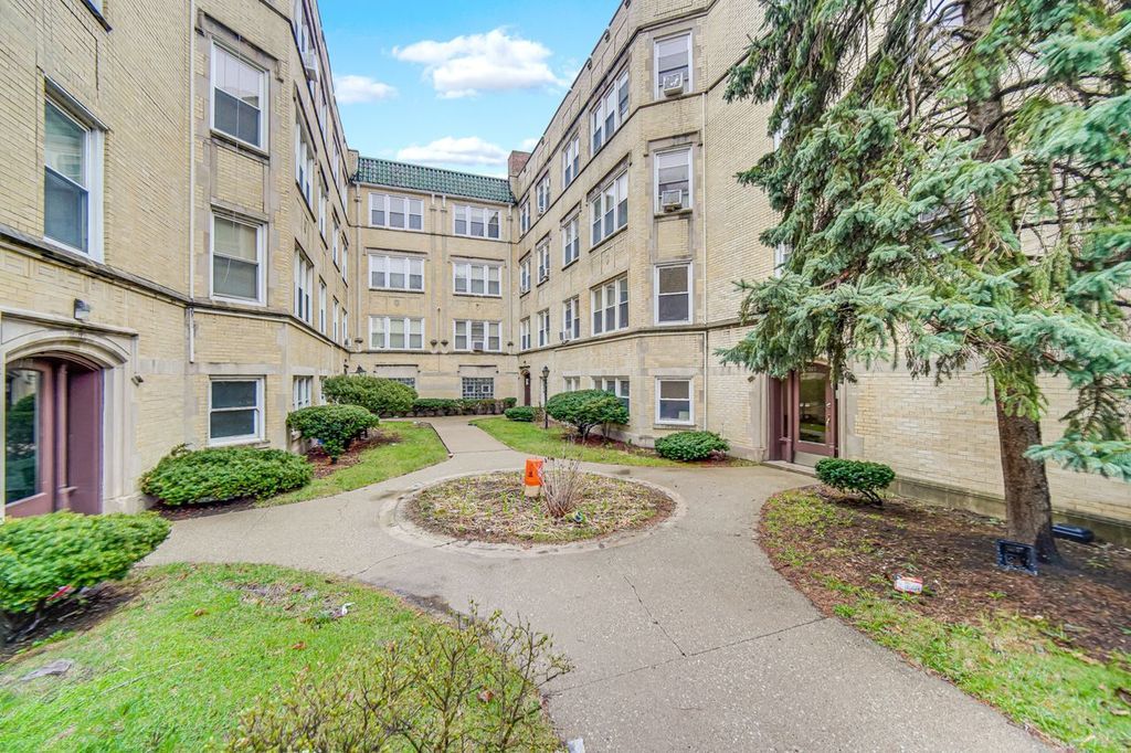 7017 South Merrill Avenue, Unit 305 Chicago, IL 60649 - Photo 5 of 20 a view of a building with a garden and pathway