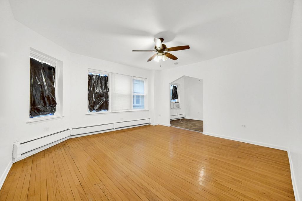 7017 South Merrill Avenue, Unit 305 Chicago, IL 60649 - Photo 8 of 20 a view of an empty room with a window