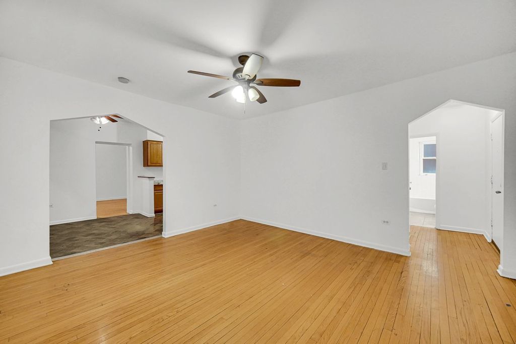 7017 South Merrill Avenue, Unit 305 Chicago, IL 60649 - Photo 9 of 20 a view of empty room with wooden floor