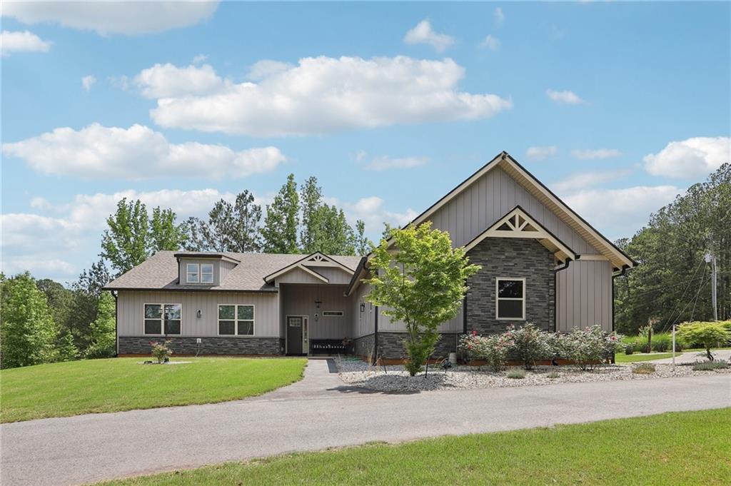 a front view of a house with a garden