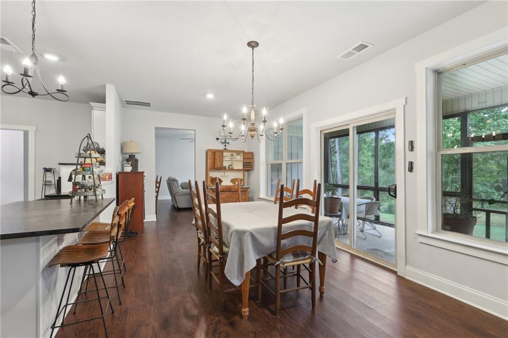 411 Johnson Road Locust Grove, GA 30248 - Photo 11 of 54 a view of a dining room with furniture window and wooden floor