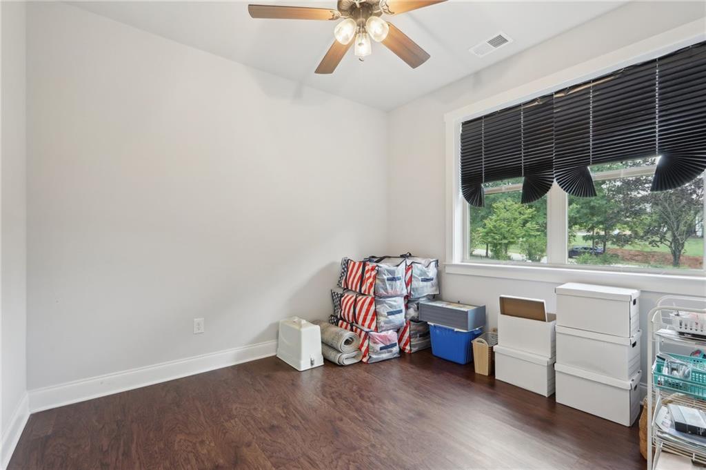 411 Johnson Road Locust Grove, GA 30248 - Photo 22 of 54 an empty room with windows and ceiling fan