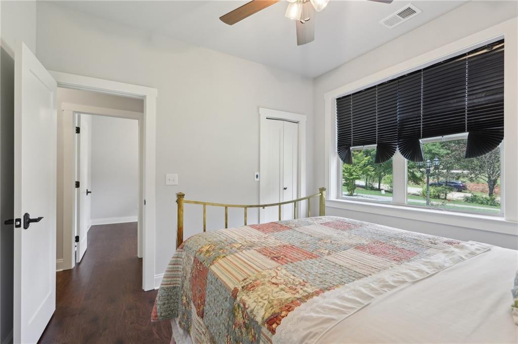 411 Johnson Road Locust Grove, GA 30248 - Photo 25 of 54 a bedroom with a bed and a large window