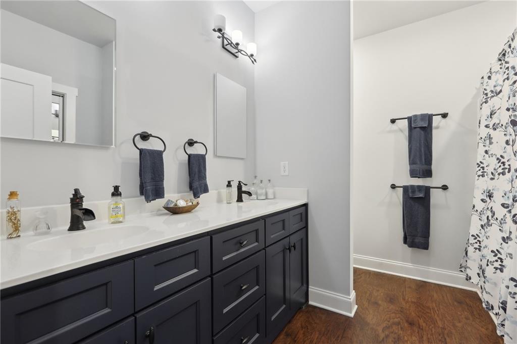 411 Johnson Road Locust Grove, GA 30248 - Photo 26 of 54 a bathroom with a sink and mirror
