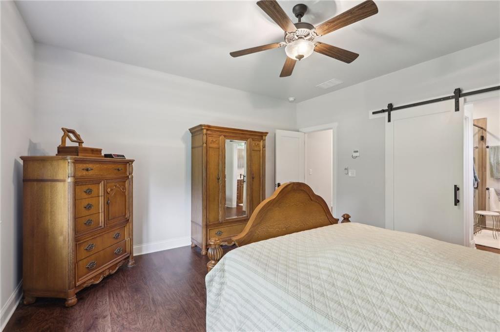 411 Johnson Road Locust Grove, GA 30248 - Photo 29 of 54 a bedroom with a bed and wooden floor