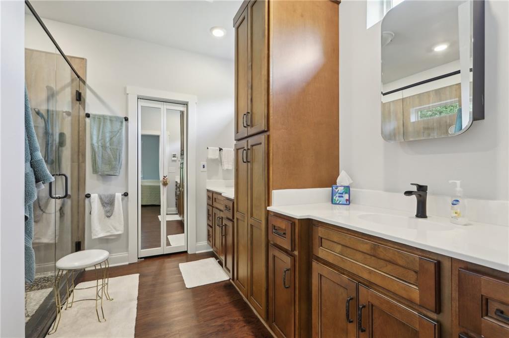 411 Johnson Road Locust Grove, GA 30248 - Photo 30 of 54 a spacious bathroom with a shower sink and mirror
