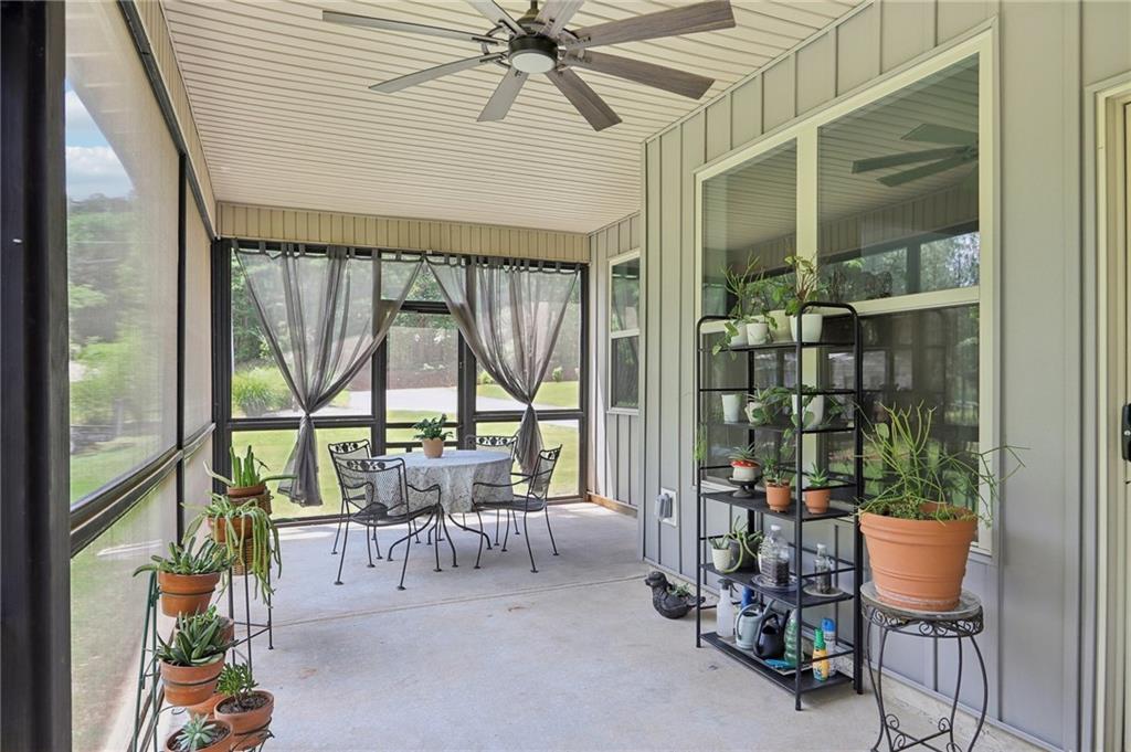 411 Johnson Road Locust Grove, GA 30248 - Photo 33 of 54 a dining room with furniture water view and a floor to ceiling window