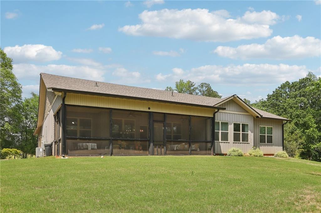 411 Johnson Road Locust Grove, GA 30248 - Photo 36 of 54 a front view of a house with a yard and garage