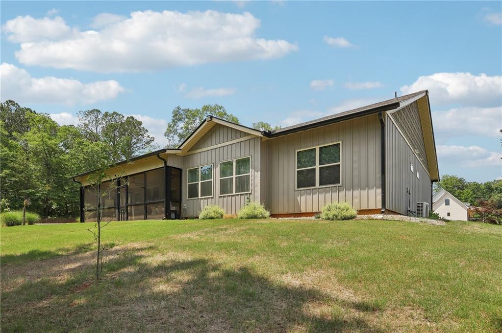 411 Johnson Road Locust Grove, GA 30248 - Photo 38 of 54 a front view of house with yard and green space
