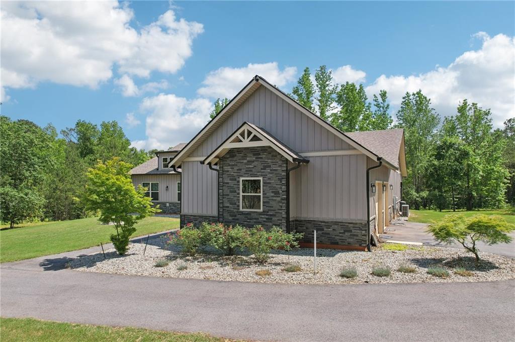 411 Johnson Road Locust Grove, GA 30248 - Photo 42 of 54 a front view of a house with a yard and garage