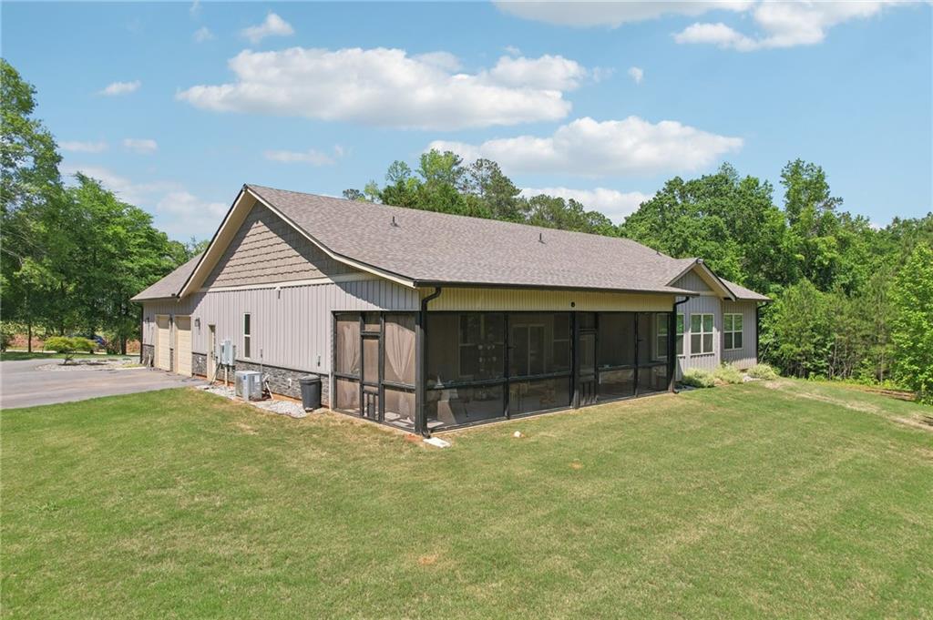 411 Johnson Road Locust Grove, GA 30248 - Photo 48 of 54 a view of a house with a yard and garage