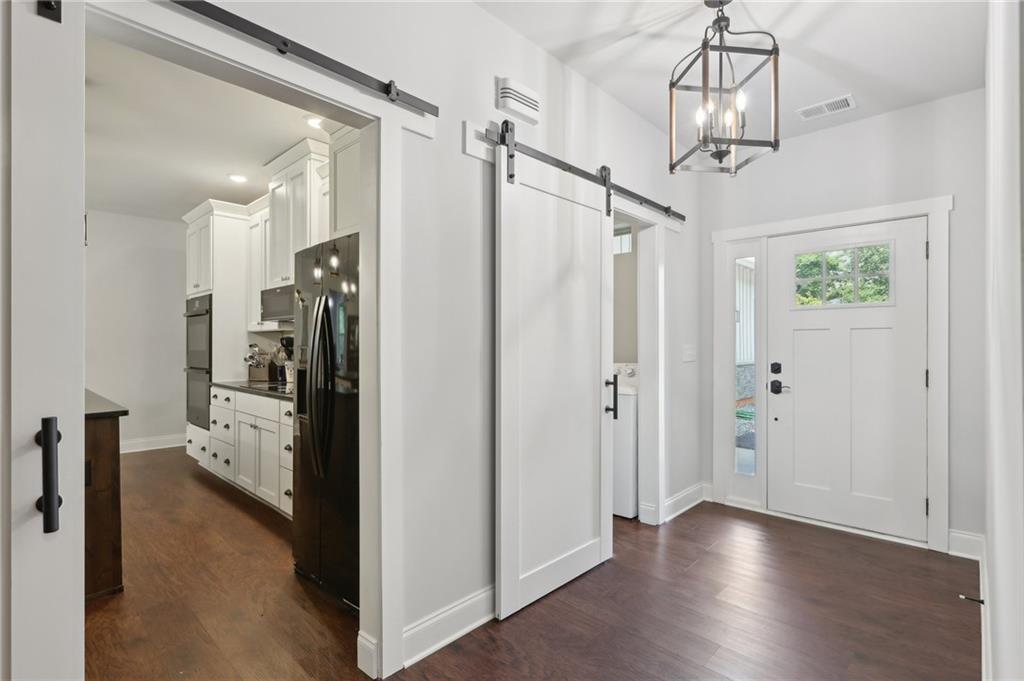 411 Johnson Road Locust Grove, GA 30248 - Photo 6 of 54 a view of a hallway view with wooden floor and staircase