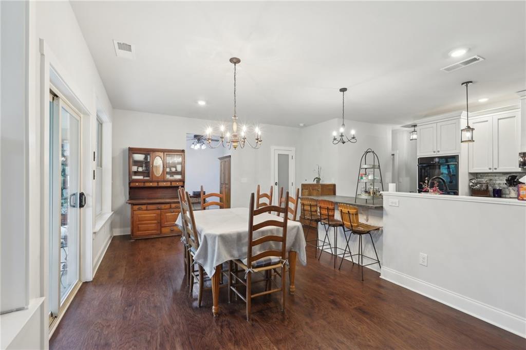411 Johnson Road Locust Grove, GA 30248 - Photo 10 of 54 a view of a dining room with furniture wooden floor and chandelier