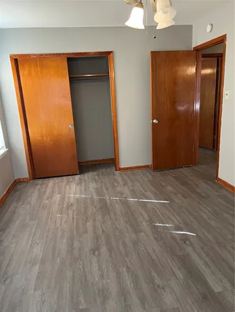 an empty room with wooden floor and a window