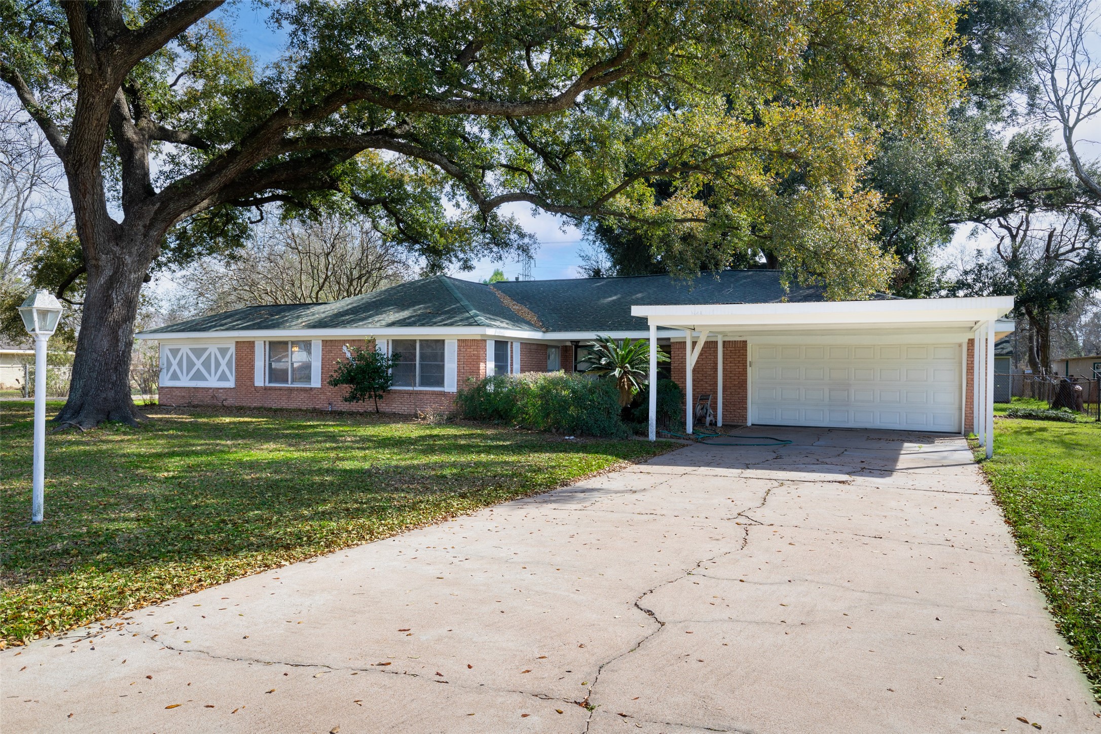 9001 Friendship Road Houston, TX 77080 - Photo 1 of 22 a view of a house with a yard and large trees