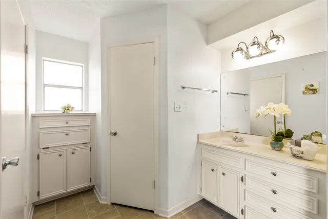 a bathroom with a sink vanity and mirror