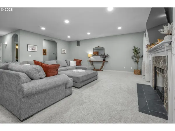 a living room with furniture a fireplace and a flat screen tv