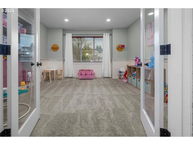 a view of a hallway with dining area and chandelier