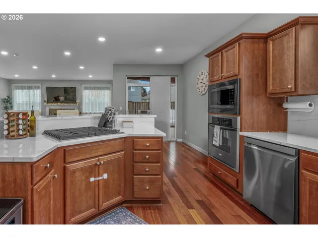 a kitchen with stainless steel appliances granite countertop a refrigerator sink and cabinets