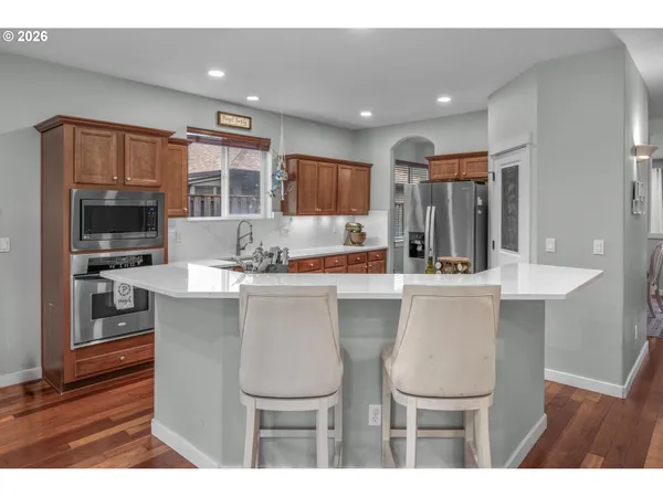 a kitchen with a table chairs refrigerator and microwave