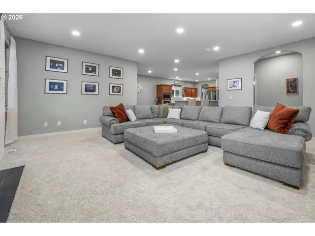 a living room with furniture and a ceiling fan