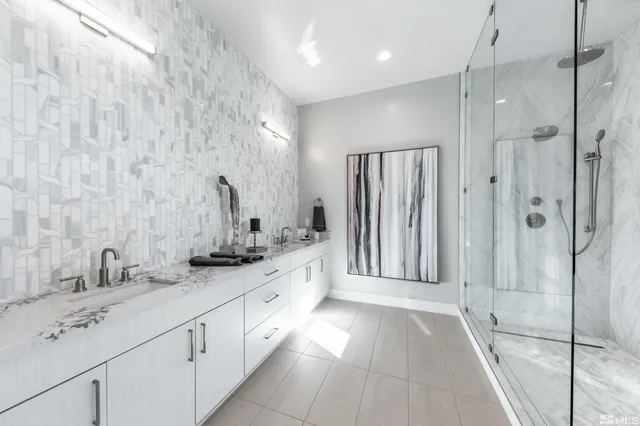 a bathroom with a double vanity sink mirror and shower