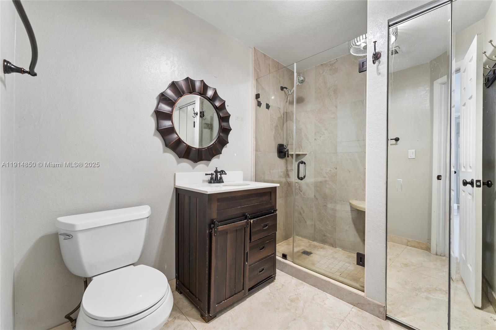 810 East 9th Place, Unit B Hialeah, FL 33010 - Photo 7 of 14 a bathroom with a toilet a sink and shower