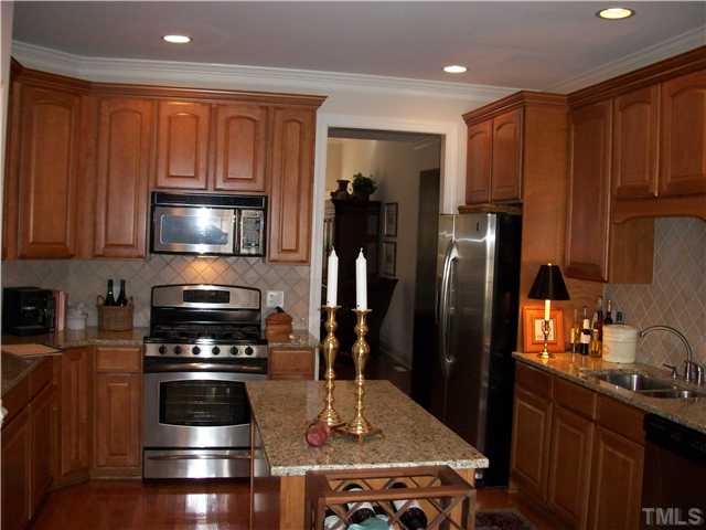 7318 Fontana Ridge Lane Raleigh, NC 27613 - Photo 5 of 23 Fabulous island kitchen, granite tops, upgraded stainless steel appliances, backslash & maple cabinets